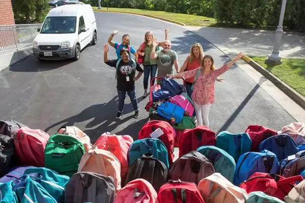 Virginia Credit Union employees fill backpacks with school supplies