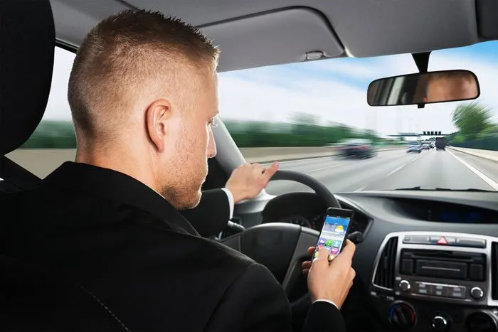 Governor’s amendment would ban using a phone while driving