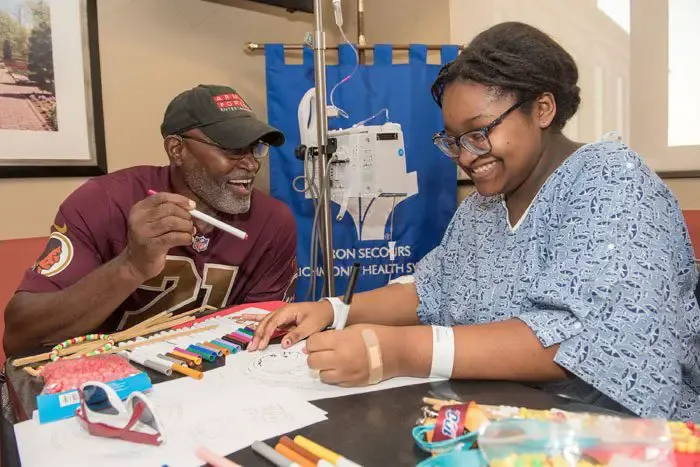 Redskins player, alumni visit pediatric patients at St. Mary's Hospital