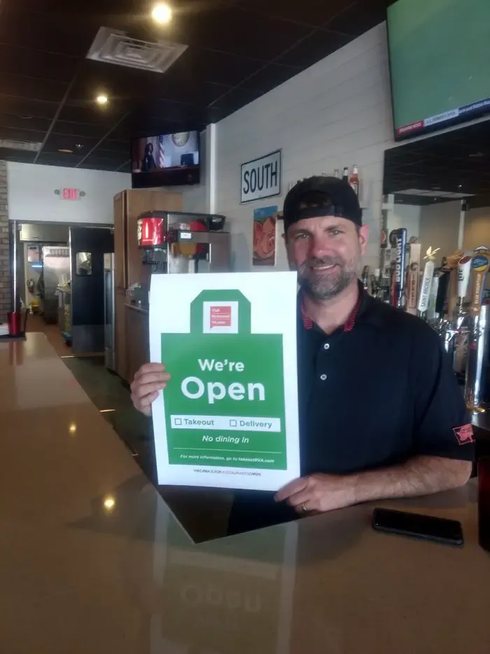 Local restaurants display ‘We’re Open’ signs